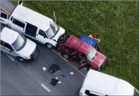  ?? JAY JANNER — AUSTIN AMERICAN-STATESMAN VIA AP ?? Officials investigat­e near a vehicle, center, where a suspect in the deadly bombings that terrorized Austin blew himself up as authoritie­s closed in on him, in Round Rock, Texas, Wednesday.