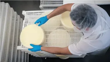  ?? DAVID PAUL MORRIS / BLOOMBERG ?? Cheese is put on a rack to dry in Nicasio, Calif. “Placing tariffs on our closest trading partners ... is concerning,” U.S. dairy farmer Russell Boening told Congress Wednesday.