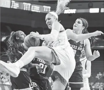  ?? Photograph­s by Ringo H.W. Chiu Associated Press ?? NICOLE KORNET of UCLA fights for a rebound with Texas A&M during the first half of a second-round game in the NCAA women’s tournament. The Bruins defeated the Aggies, 75-43, and face Connecticu­t next.