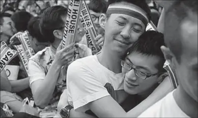  ??  ?? Activists hug outside the parliament in Taipei as they celebrate after the court ruled in favour of same-sex unions. (Photo: AFP)