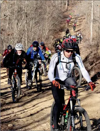  ??  ?? A wave of cyclists tackles the challengin­g climb that began the 12th annual Buffalo Headwaters Challenge on Jan. 28.
