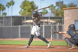  ?? PHOTOS BY MONICA D. SPENCER/THE REPUBLIC ?? Cam Caminiti, a freshman on Saguaro High School's varsity baseball team, bats during a home game against Marcos de Niza in Scottsdale on Tuesday.