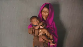  ?? (Mohammad Ponir Hossain/Reuters) ?? RAHAMA KHATUN, 35, poses with her son at the Kutupalong camp in Cox’s Bazar, Bangladesh, last month.