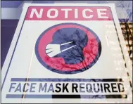  ?? (AP/Matt Rourke) ?? A sign requiring masks as a precaution against the spread of the coronaviru­s greets visitors to a Philadelph­ia store in February. The city is renewing an indoor mask mandate beginning today.