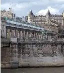  ?? Bloomberg ?? A Paris Metro train travels on a bridge across the River Seine, in central Paris, on Feb. 14.