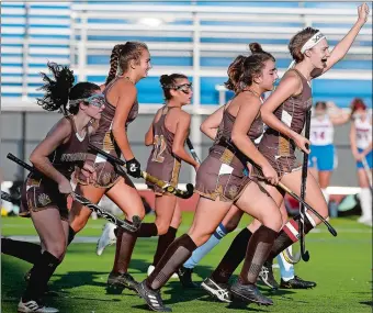  ?? SARAH GORDON/THE DAY ?? Stonington’s Ellie Korinek, right, celebrates one of her two goals with teammates during Thursday’s 6-0 field hockey victory over host Waterford. Visit www.theday.com to view a photo gallery.