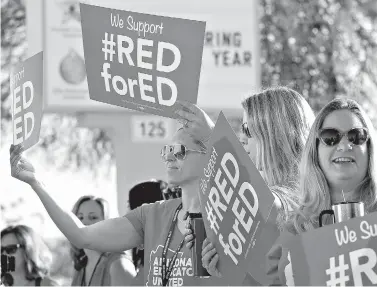  ?? AP Photo/Matt York ?? ■ Teachers at Humphrey Elementary School participat­e in a statewide walk-in prior to classes Wednesday in Chandler, Ariz. Arizona teachers are demanding a 20 percent pay raise and more than $1 billion in new education funding.