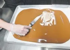  ?? Helen H. Richardson, The Denver Post ?? Megan Irvine makes chocolate bark on Feb. 7 at Chocolate Lab in Denver.