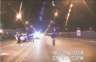  ?? Chicago Police Department 2014 ?? Laquan McDonald (right) is seen walking down the street on police dash-cam video moments before being shot by Chicago police Officer Jason Van Dyke on Oct. 20, 2014.