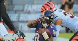  ?? KARL MERTON FERRON/BALTIMORE SUN ?? Cincinnati defensive tackle Larry Ogunjobi, left, and Jessie Bates III halt the progress of Ravens quarterbac­k Lamar Jackson, who fails to convert on fourth down during a 41-17 Bengals victory in October at M&T Bank Stadium. Cincinnati, the AFC champion, won both matchups last season.