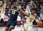  ?? JIM MONE - STAFF, AP ?? Michigan’s Chaundee Brown, left, defends as Minnesota’s Marcus Carr drives with the ball in the first half of Saturday’s game in Minneapoli­s.