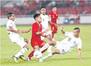  ?? EPA ?? Indonesia’s Andik Vermansah, centre, in action against Timor Leste in the Suzuki Cup in Jakarta last night.