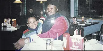  ?? The Associated Press ?? Olusegun Olatunji, a native of Nigeria, and his son, Micah, at a Denny’s restaurant in Bloomingto­n, Ind., in 2007. Olatunji overstayed a work visa 30 years ago. In 2013, he was convicted of selling counterfei­t hats and received a deportatio­n order.