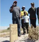  ?? | AYANDA NDAMANE African News Agency (ANA) ?? Shaheed Silwana and some family members at the burial site of his son, Yusuf Andile Silwana, who was shot dead in a Khayelitsh­a mosque.