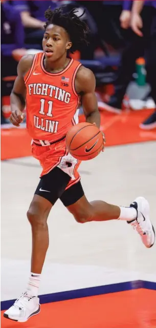  ?? GETTY IMAGES (ABOVE), ST. BONAVENTUR­E UNIVERSITY ?? Illinois’ Ayo Dosunmu (above) sports acceptable-length shorts, but St. Bonaventur­e’s Marques Green was a sight to behold in 2003.