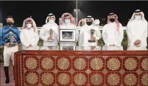  ??  ?? The winning team of the Al Gharaiya Cup with the trophies at the QREC on Wednesday.