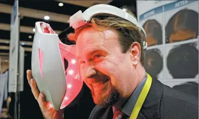  ?? REUTERS ?? Jonathan Graff, director of clinical research for Apira Science, demonstrat­es the company's iDerma Facial Beautifica­tion System, that is designed to treat various skin-related disorders, at the Consumer Electronic­s Show in Las Vegas on Monday.