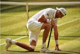  ?? Oli Scarff / AFP/Getty Images ?? John Isner, who has participat­ed in the two longest matches in Wimbledon history, would like to see all Grand Slam events implement a fifth-set tiebreaker.