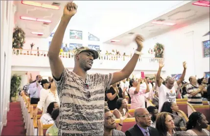  ?? ALLEN EYESTONE / THE PALM BEACH POST ?? David Thomas of West Palm Beach sings words of praise Monday night during a community rally and benefit for the family of Corey Jones held at Hilltop Missionary Baptist Church in Riviera Beach. Hundreds of people attended the event.