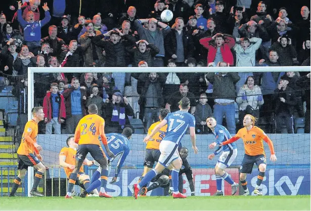  ?? Sean Hansford ?? ●●Oldham goalkeeper Johnny Placide makes a point blank save to deny Rochdale during Tuesday’s derby clash at the Crown Oil Arena