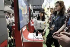  ?? AP file photo ?? Visitors to the Pax East conference play the new Nintendo Switch video game Animal Crossing on Feb. 27 in Boston.