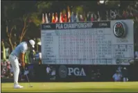  ?? The Associated Press ?? GOING FOR ANOTHER: Brooks Koepka putts on the 18th green Saturday during the third round of the PGA Championsh­ip at Bellerive Country Club in St. Louis.