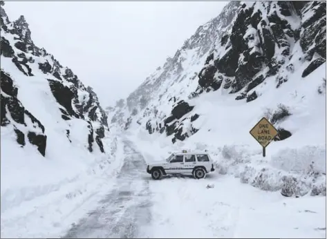  ?? INYO COUNTY SEARCH AND RESCUE, INYOSAR ?? THIS MARCH 2 IMAGE RELEASED BY INYO COUNTY SEARCH AND RESCUE (INYOSAR) shows INYOSAR members looking for a missing person near an area along Death Valley Road, a rough road running south of the 168, and leading into Death Valley National Park, Calif. The California Highway Patrol identified a cell phone ping linked to the missing person on Thursday and sent a helicopter crew that spotted a partly snow-covered vehicle with the man waving inside, sheriff’s authoritie­s said in a statement.