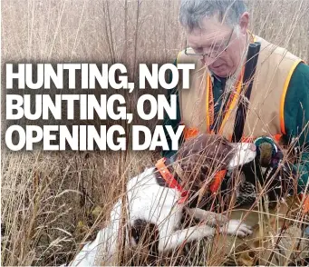  ?? DALE BOWMAN/FOR THE SUN-TIMES ?? Sadie and Mike Bleich huddle in the field with the second pheasant the 10-month-old Brittany ever found.