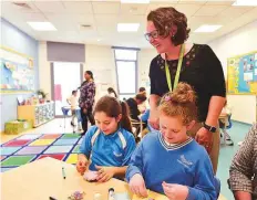  ?? Clint Egbert/Gulf News ?? Julie Hoyland with Kimia (right) and another student. She was instrument­al in helping Kimia fit in with other students.