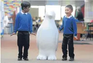  ??  ?? Our Lady’s RC Primary School pupils Moaz Sheak and Jeromy Wei with one of the penguins.