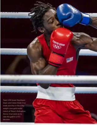  ?? ?? Team USA boxer Keyshawn Davis and Cuban Andy Cruz trade punches in the 63kg weight class gold medal match at Tokyo's Kokugikan Arena. Cruz went on to take the gold in a 4-1 decision.