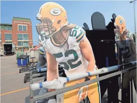  ?? ADAM WESLEY / USA TODAY NETWORK-WISCONSIN ?? Clay Matthews figures are part of the Packers Experience being set up outside Lambeau Field on Monday.