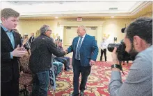  ?? JULIE JOCSAK THE ST. CATHARINES STANDARD ?? Ontario PC leader Doug Ford greets supporters on his way into a rally at the Holiday Inn in St. Catharines April 4.