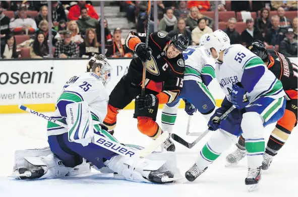  ?? — GETTY IMAGES ?? Vancouver Canucks defenceman Alex Biega and goaltender Jacob Markstrom defend against Anaheim Ducks centre Ryan Getzlaf during the first period of Wednesday night’s game in Anaheim, Calif. The Canucks were shut out for a third straight game in the loss.