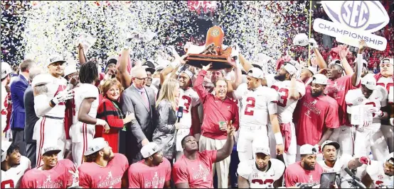  ??  ?? Head coach Nick Saban and the Alabama Crimson Tide celebrate with the trophy after defeating the Georgia Bulldogs 35-28 in the 2018 SEC Championsh­ip Game at Mercedes-Benz Stadiumon Dec 1, in Atlanta, Georgia. (AFP)