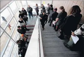  ?? Bronte Wittpenn Flint Journal ?? JOB SEEKERS wait in line during a hiring fair last month in Flint, Mich. On Friday, the Labor Department said black unemployme­nt had ticked up to 7.7%.