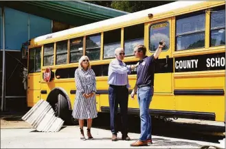  ?? Evan Vucci / Associated Press ?? President Joe Biden, first lady Jill Biden and Kentucky Gov. Andy Beshear, view flood damage on Monday in Lost Creek, Ky., where a bus floated into a building.