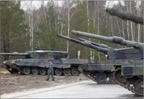  ?? ?? The Associated Press
A Polish soldier walks next to the Leopard 2 tanks during a training at a military base and test range in Swietoszow, Poland. The training is part of the European Union's military assistance to Ukraine.