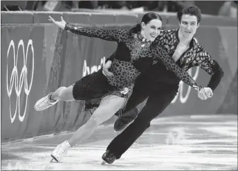  ?? AP PHOTO/JULIE JACOBSON ?? Tessa Virtue and Scott Moir of Canada perform during the ice dance, short dance figure skating in the Gangneung Ice Arena at the 2018 Winter Olympics in Gangneung, South Korea, on Monday.