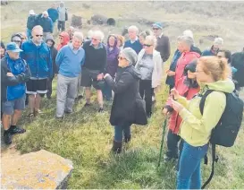  ?? Photo / Supplied ?? Pa¯ tea Historical Society president Jacq Dwyer (centre) tells Whanganui Summer Programme participan­ts about a Pa¯ tea hydro scheme.