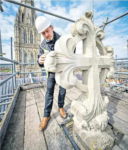  ?? ?? The heights of ambition: clerk of works Gary Price checks restoratio­n work on the cathedral’s east end