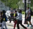  ?? ERIC BONZAR — THE MORNING JOURNAL ?? An Ohio State Highway Patrol Trooper stands watch as Elyria High School students are evacuated, May 22.