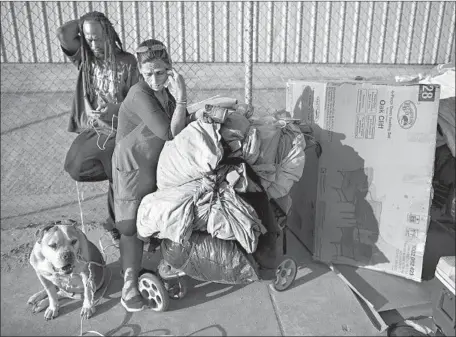  ?? Photograph­s by Gina Ferazzi Los Angeles Times ?? A HOMELESS COUPLE and their dog are shown in May in Sunland. At that point, they had been living on the street for six months.