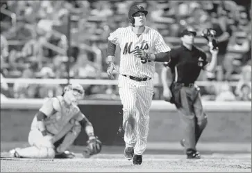  ?? Mike Stobe Getty Images ?? KELLY JOHNSON of the New York Mets watches his home run in the fifth inning against Zach Lee of the Dodgers. Catcher Yasmani Grandal and plate umpire Jim Reynolds follow the f light path, too.