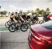  ?? ?? Cyclists alongside cars on the Rickenback­er Causeway.