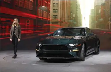  ?? BILL PUGLIANO/GETTY IMAGES ?? Molly McQueen, the granddaugh­ter of actor Steve McQueen, introduces the 2018 Ford Mustang Bullitt in Detroit.