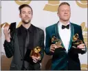  ?? PHOTO BY DAN STEINBERG/INVISION/AP, FILE ?? Ryan Lewis, left, and Macklemore pose in the press room with their awards for best rap performanc­e and best rap song, for "Thrift Shop," best rap album for "The Heist" and best new artist at the 56th annual Grammy Awards in Los Angeles in 2014.