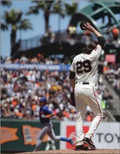  ?? Bay Area News Group/tns ?? San Francisco Giants pitcher Jeff Samardzija wipes his face as New York Mets’ Jeff Mcneil, left, runs the bases after hitting a two run home run in the fifth inning of a baseball game Saturday in San Francisco.