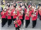  ??  ?? ●●The Wardle parade makes its way through the village