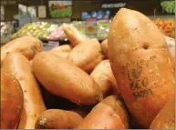  ?? AP PHOTO/JAMES BROOKS ?? In this photo taken Jan. 31, laser branded sweet potatoes are displayed at the ICA Kvantum supermarke­t in Malmo, Sweden. Something high-tech is happening in the produce aisle at some Swedish supermarke­ts, where laser marks have replaced labels on the...